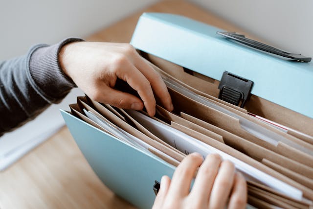 person-looking-for-a-document-in-a-file-folder