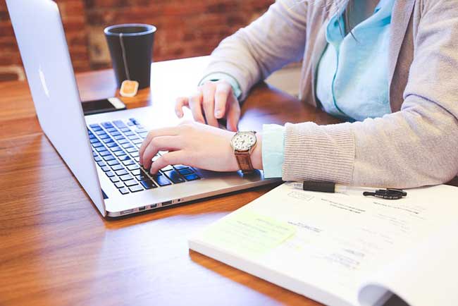 person typing on laptop